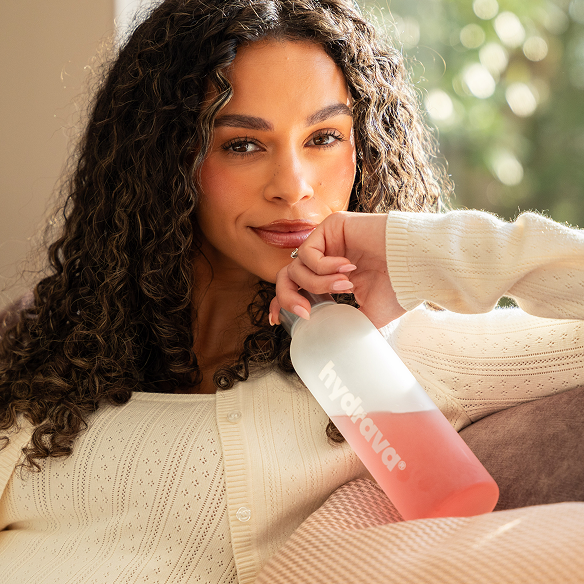 Woman holding a Hydrava bottle